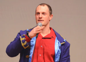 Professor Poythress holding a mic on stage