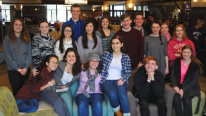 students gather in the campus center for a picture before leaving